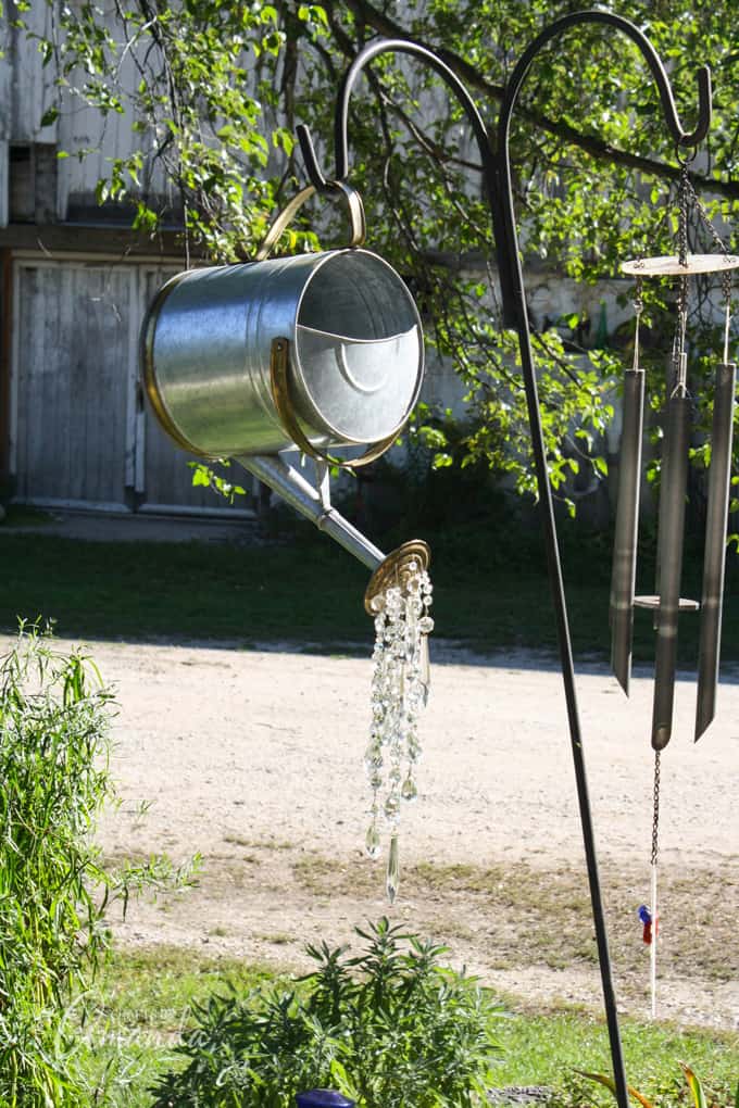 A Watering Can That Pours Crystals hanging in garden