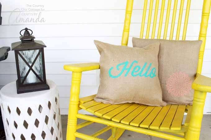 Stenciled burlap pillow covers on yellow chair