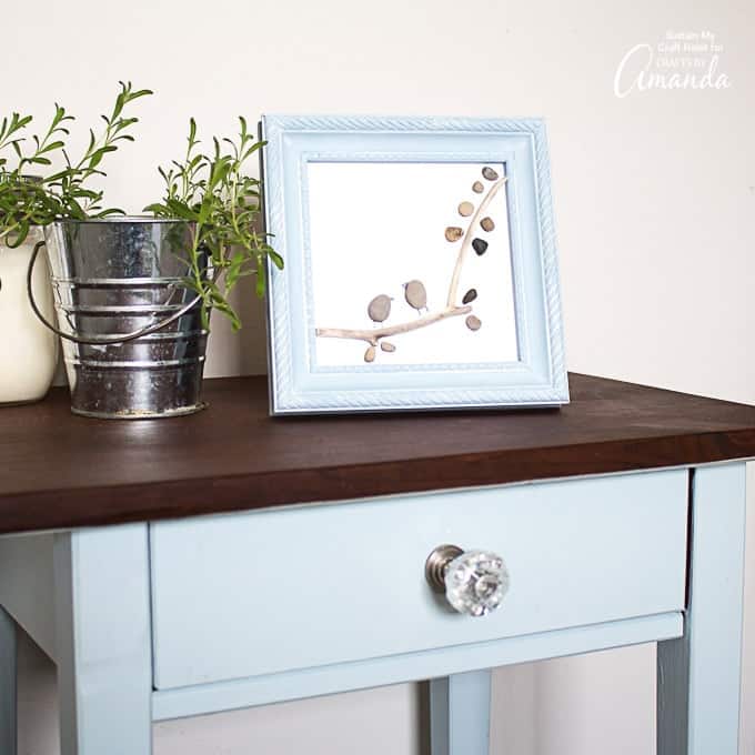 pebble art in frame on table