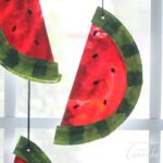 Watermelon suncatchers are a fun summer craft kids can make with adults. This suncatcher is made from paper plates, paint, and melted crayons!