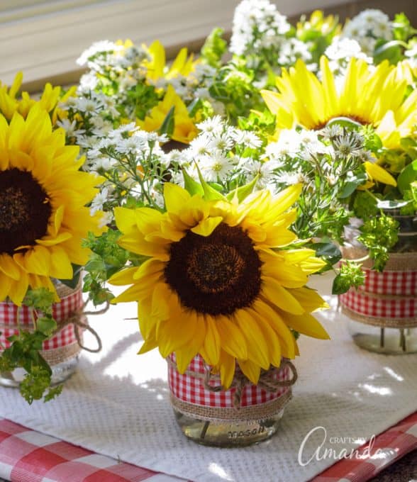 Mason Jar Centerpieces Sunflower filled jars decorated with burlap