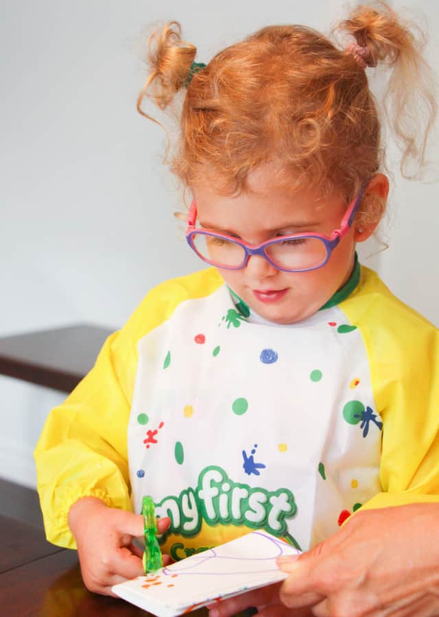 toddler cutting paper