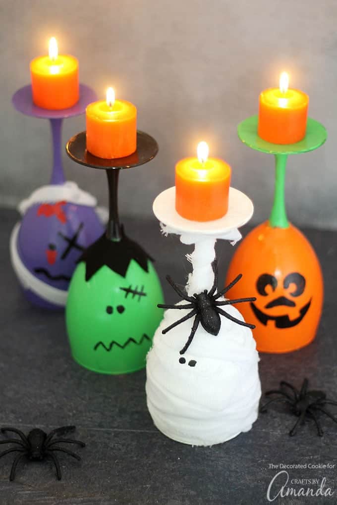 Wine glasses painted like Frankenstein, a mummy, and a pumpkin with candles