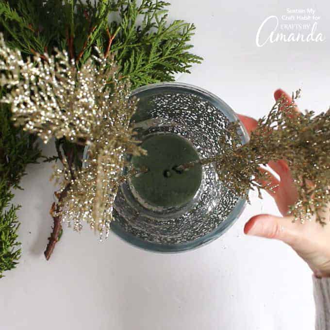 Add pieces of greenery to floral foam