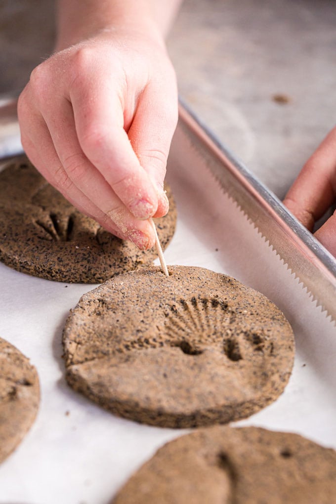 child making hole in salt dough for a hanger