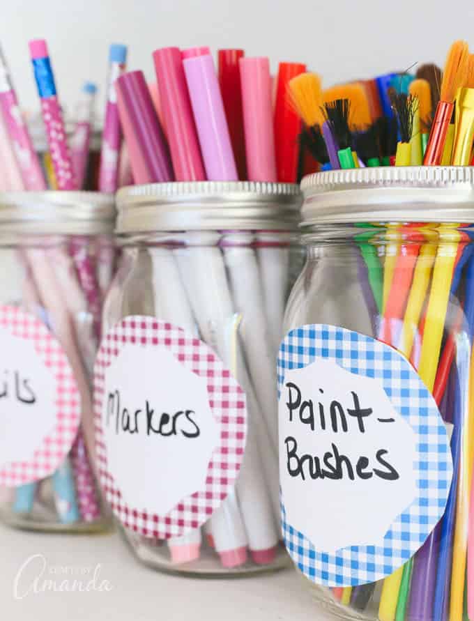 markers and pencils in labeled jars