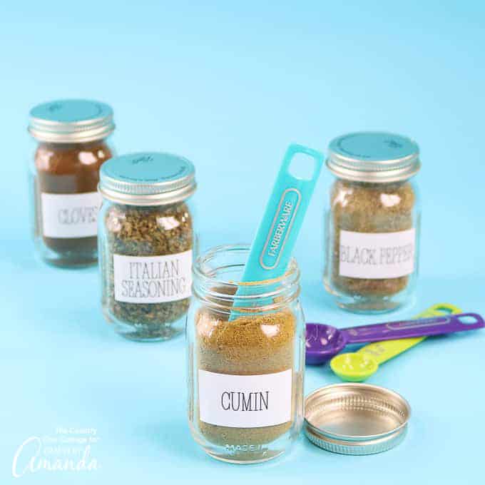 mason jars filled with spices and labeled with Cricut vinyl