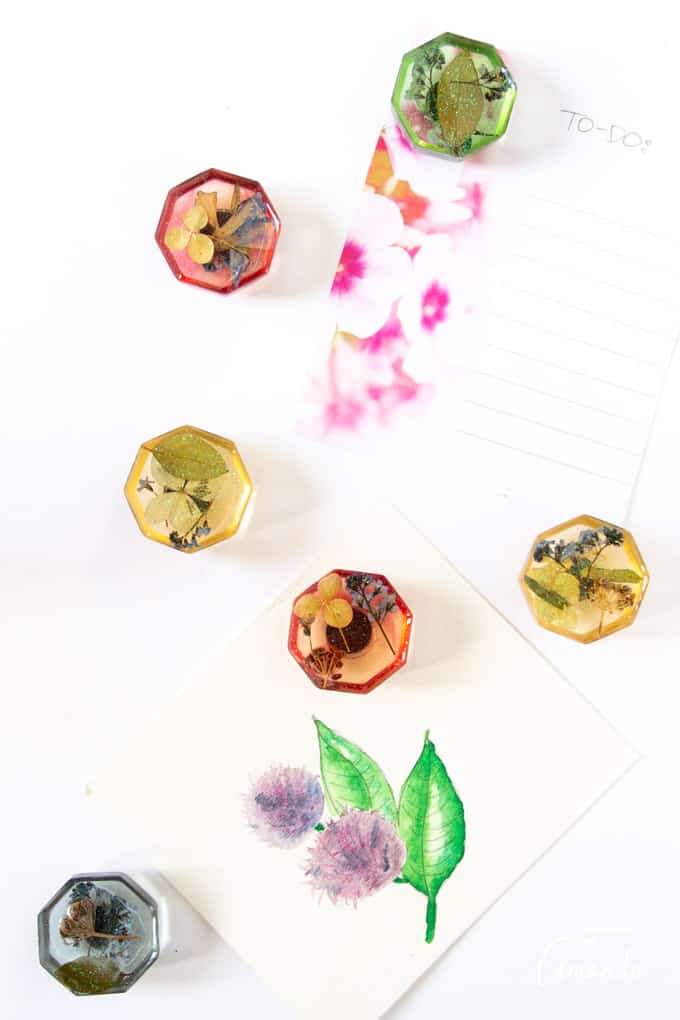 Resin magnets with pressed flowers on fridge