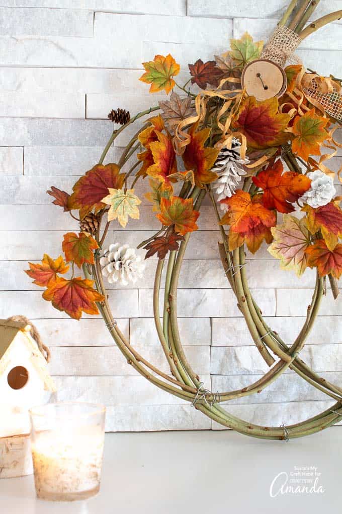 pumpkin grapevine wreath against wall