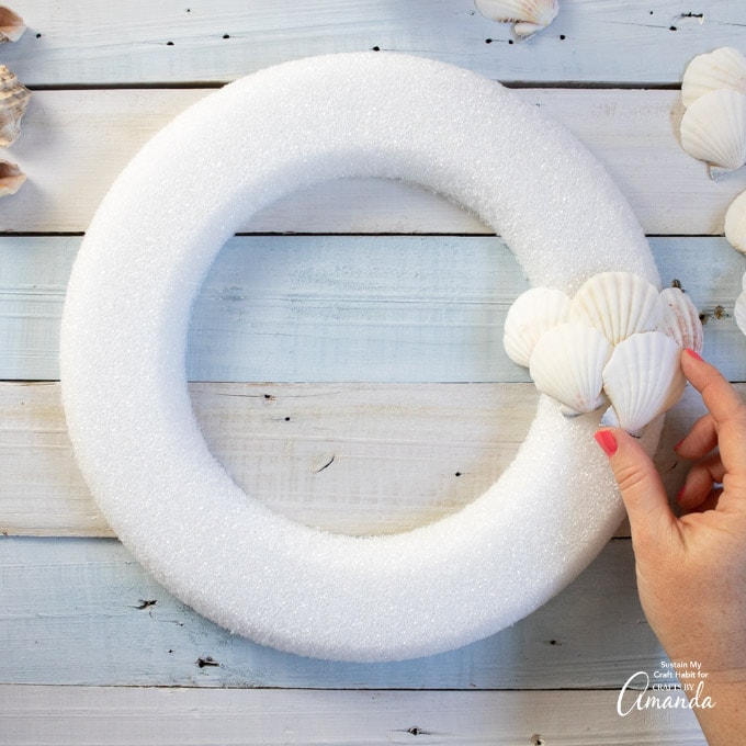 arranging seashells on wreath form