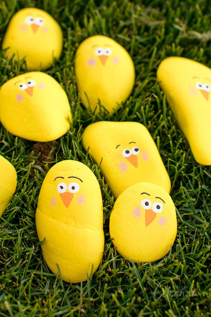 painted rock chicks in the grass