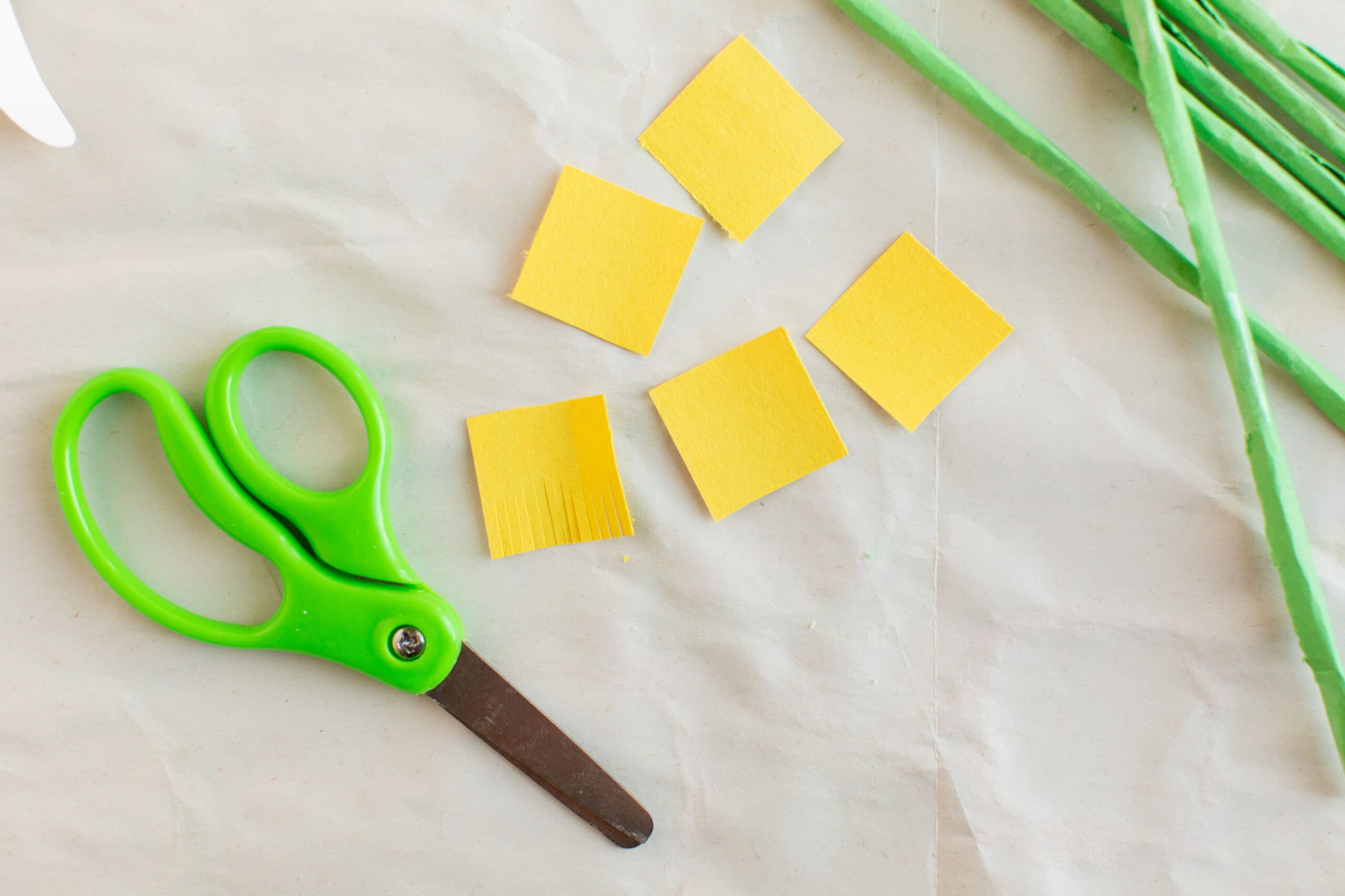 yellow construction paper squares cut with fringe