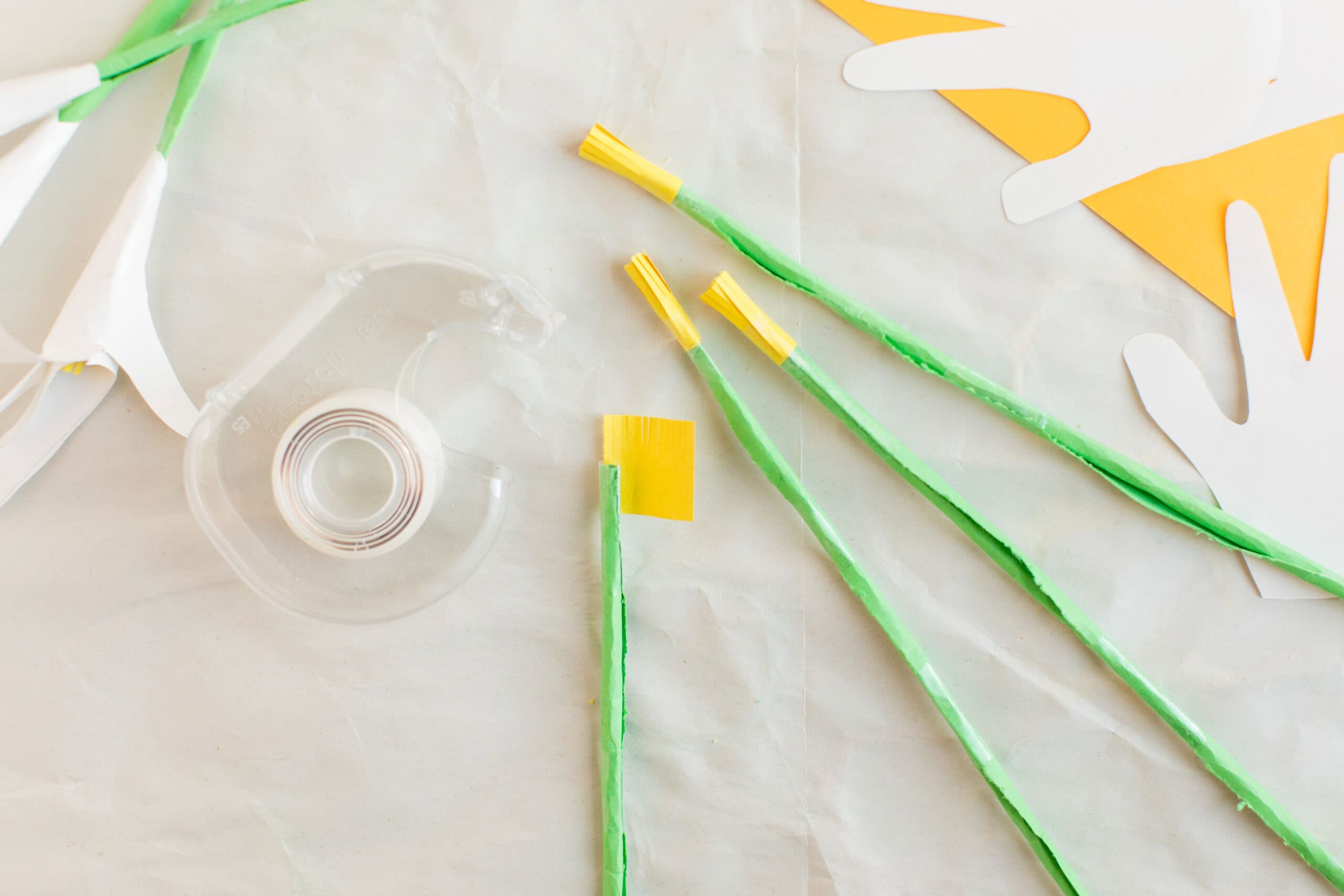 wrapping yellow construction paper around choptstick