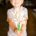 boy holding handprint easter lily bouquet