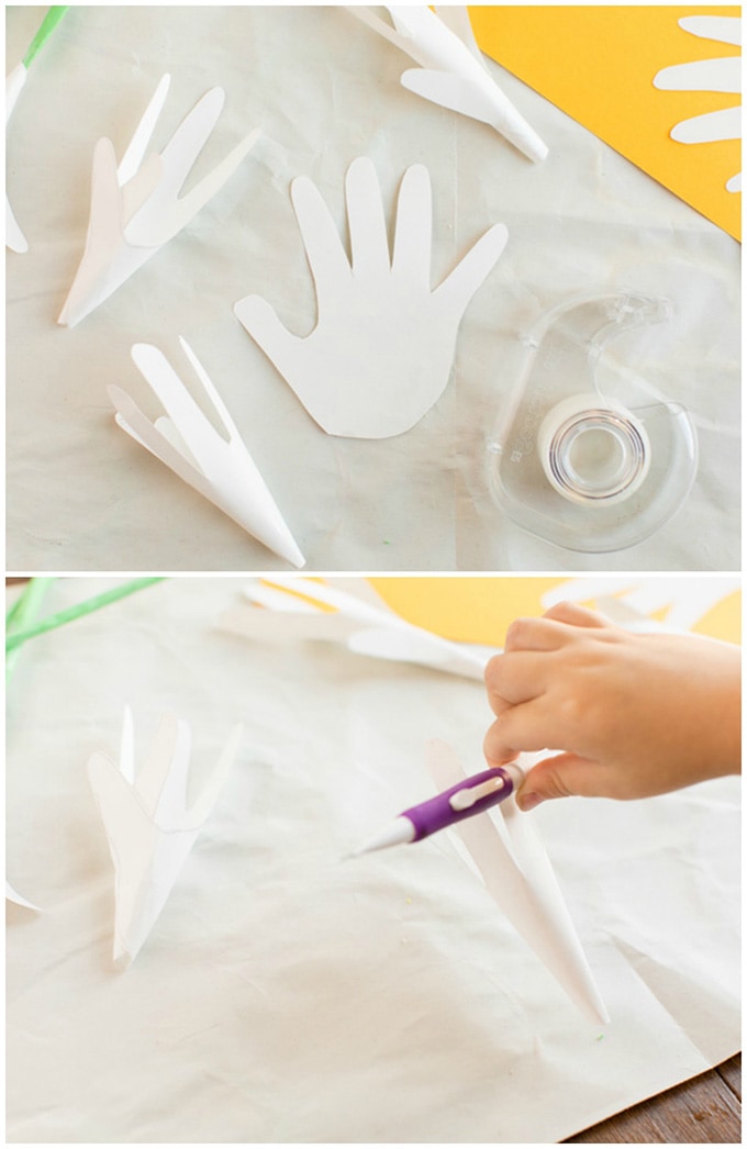 rolling up paper handprints to make into easter lily flowers