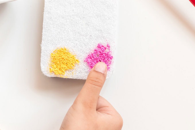 pressing finger into paint on sponge