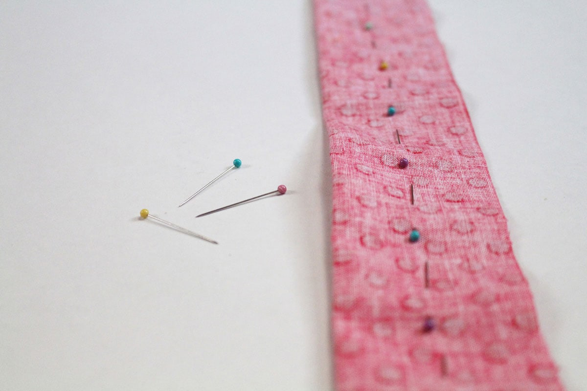 pins in a strip of fabric
