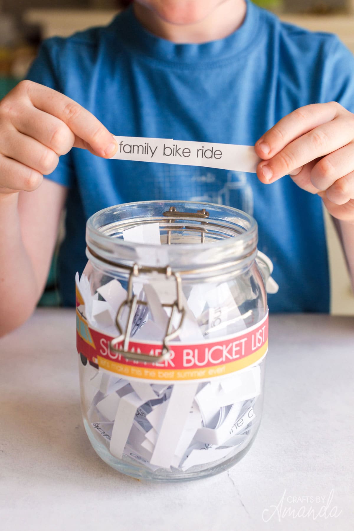 pulling slip of paper from jar
