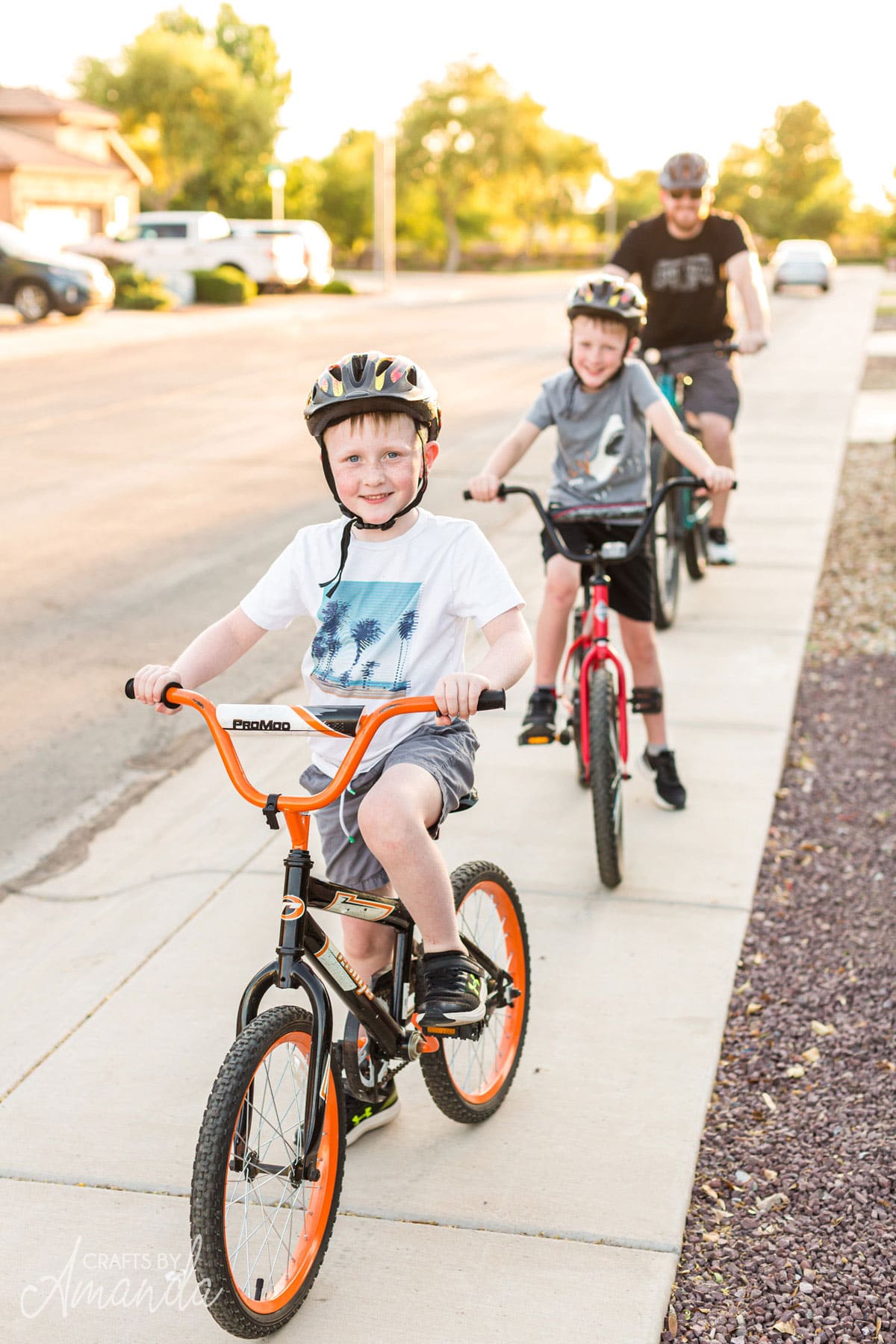 little boys and dad on a family bike ride