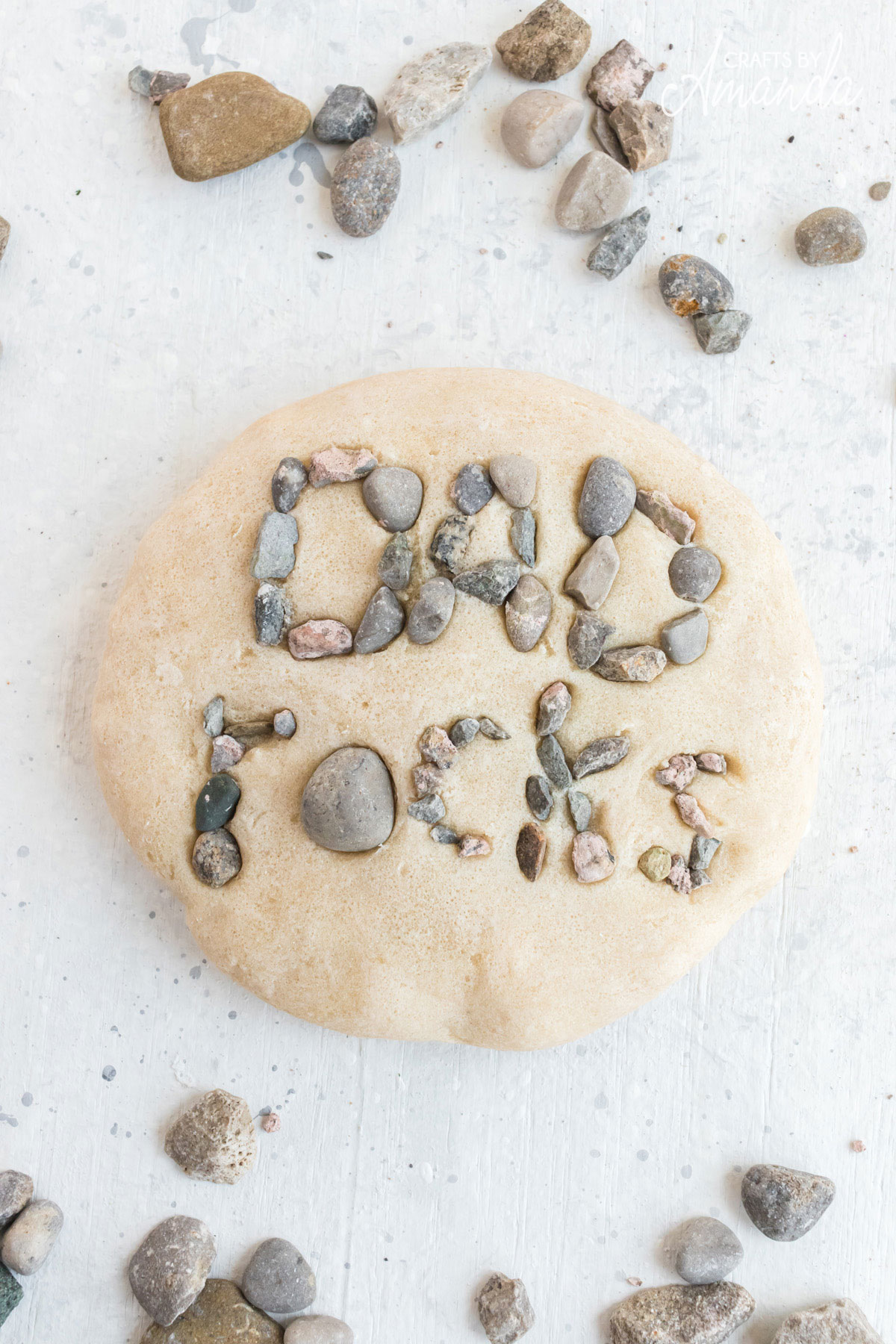 salt dough paperweight that spells out dad rocks in actual rocks
