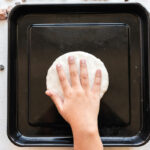 child flattening salt dough