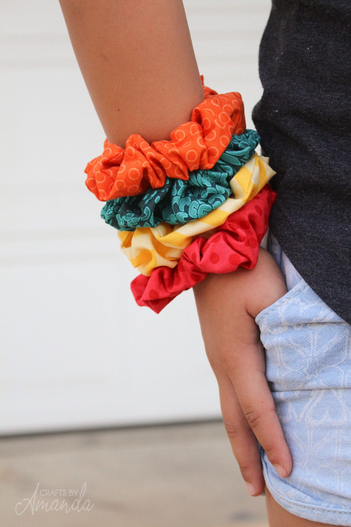 colorful scrunchies on a little girl's wrist