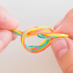 tying a knot with floss