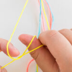 hands moving embroidery floss