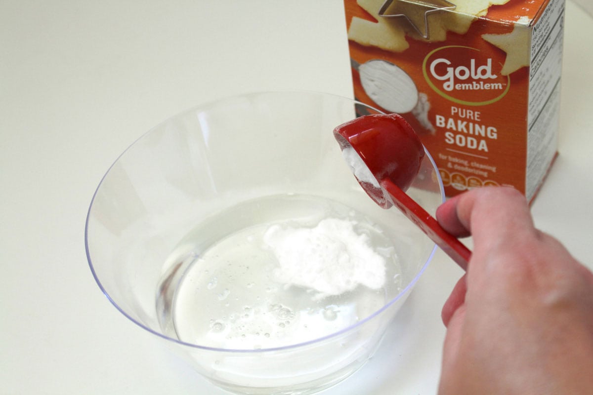 adding baking soda to bowl