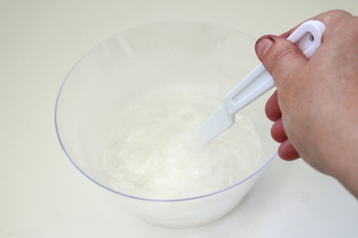 stirring slime mixture in bowl