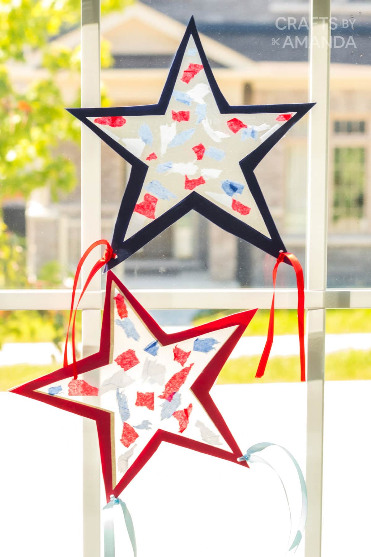 two star shaped suncatchers in a windw