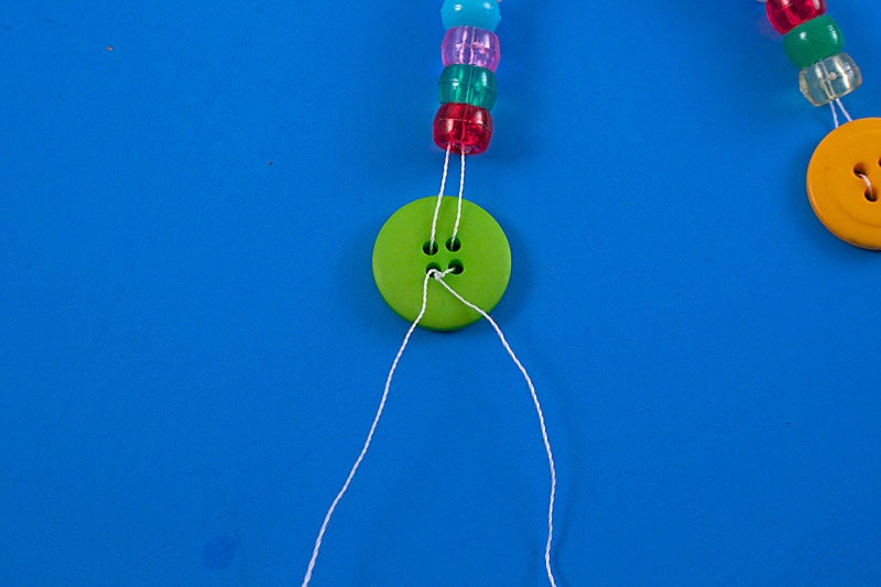 tying string in knot at back of button