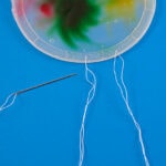 threading needle through plastic lid