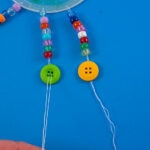 threading string through button holes