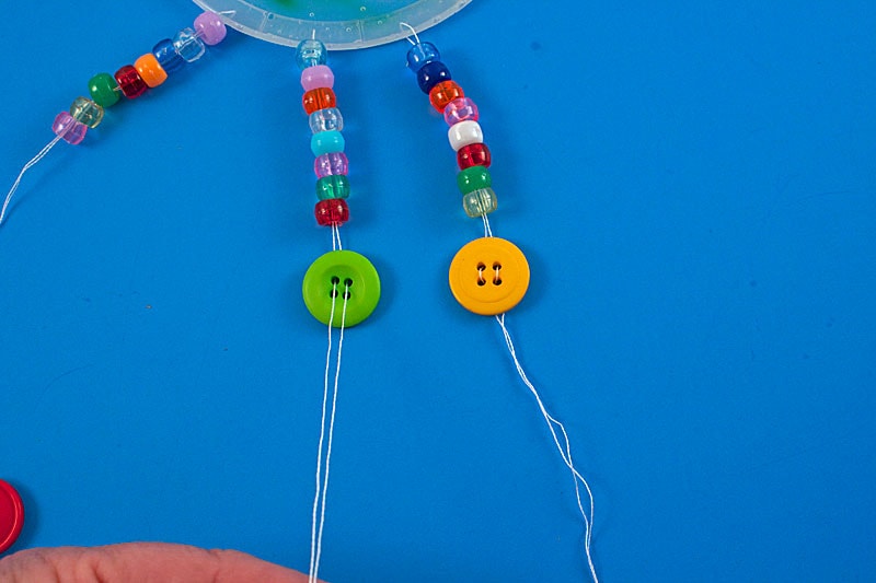 threading string through button holes