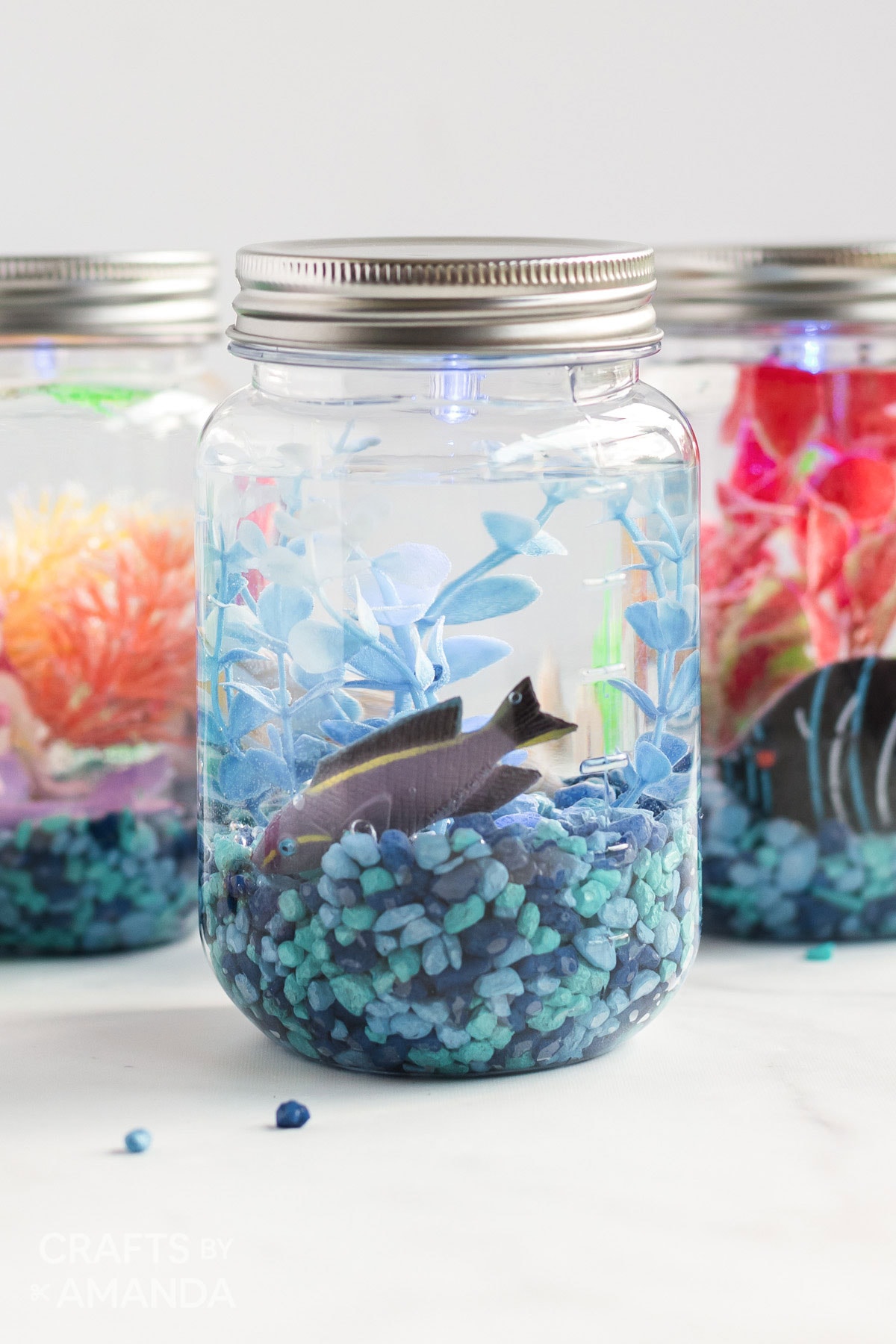 3 mason jar aquariums with plastic fish