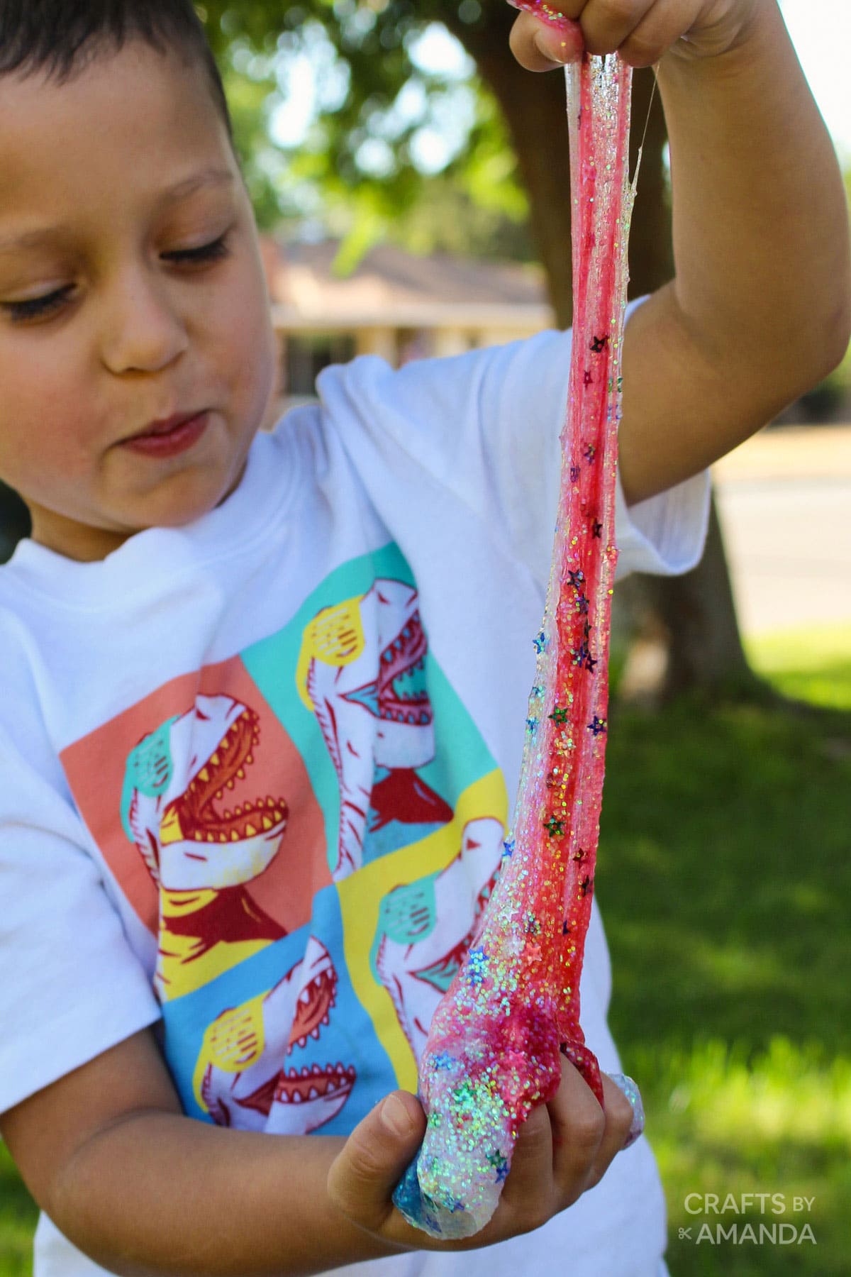 little boy stretching patriotic slime