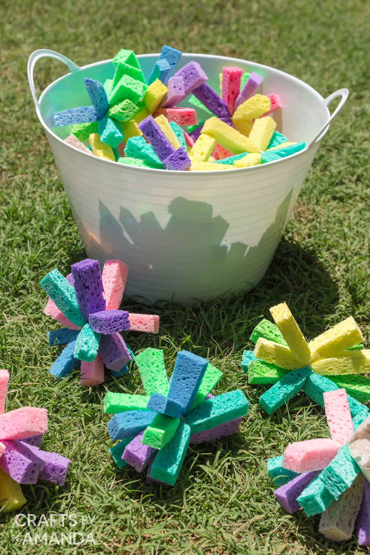 BUCKET OF SPONGE BOMBS SITTING IN THE GRASS