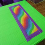 rainbow duct tape over green an purple duck tape on cereal box