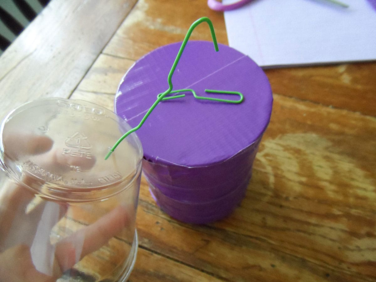 paper clips poked into plastic cup