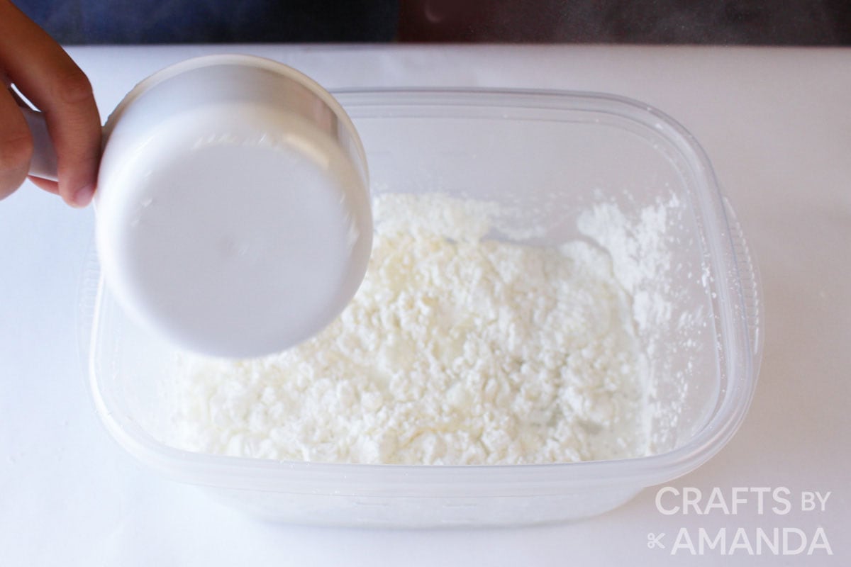 adding cornstarch to a container of water
