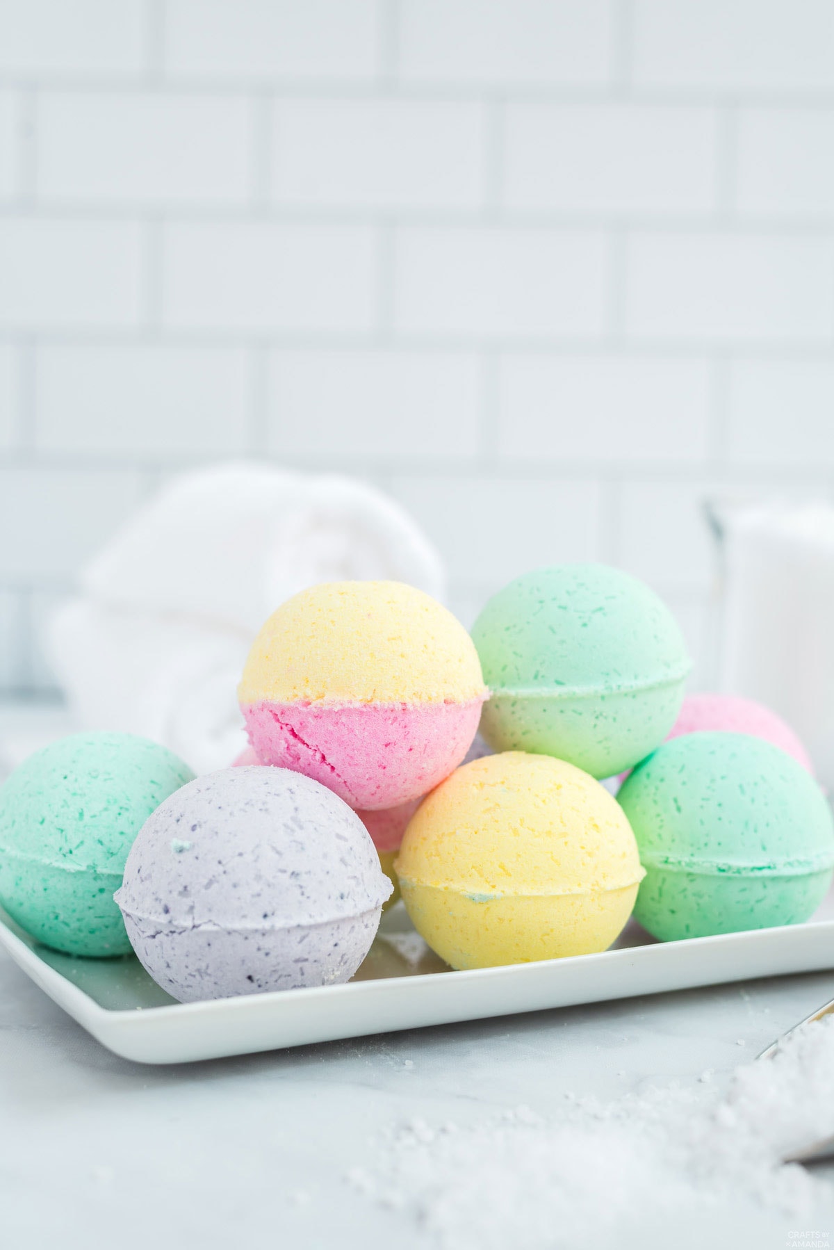 tray of colorful bath bombs on bathroom counter