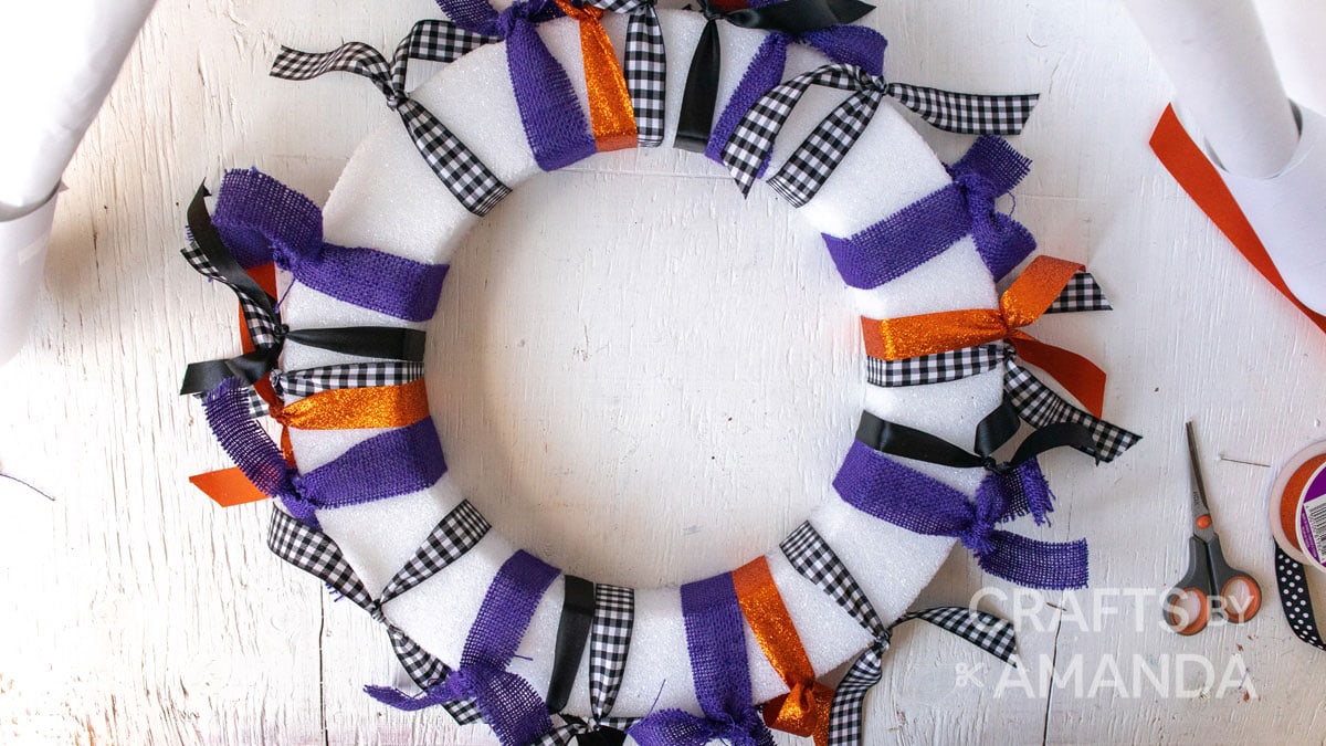multiple ribbons tied around a wreath form