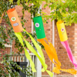 3 MONSTER WINDSOCKS HANGING FROM TREE