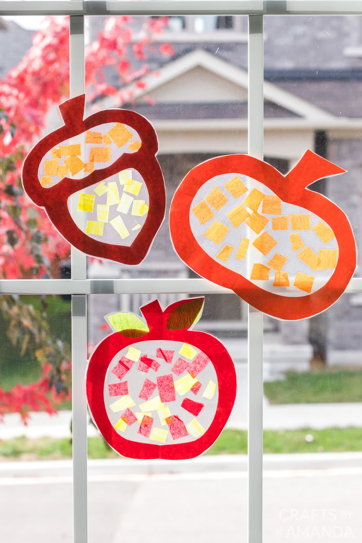 3 fall themed sun catchers on a window