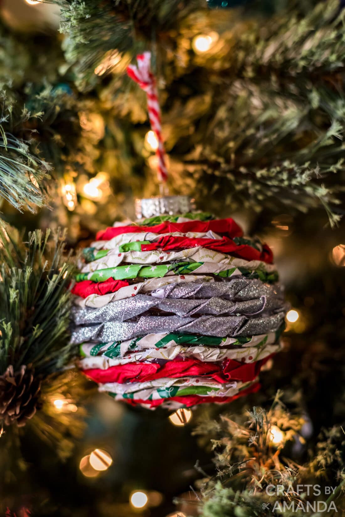 twisted paper ornament hanging on Christmas tree