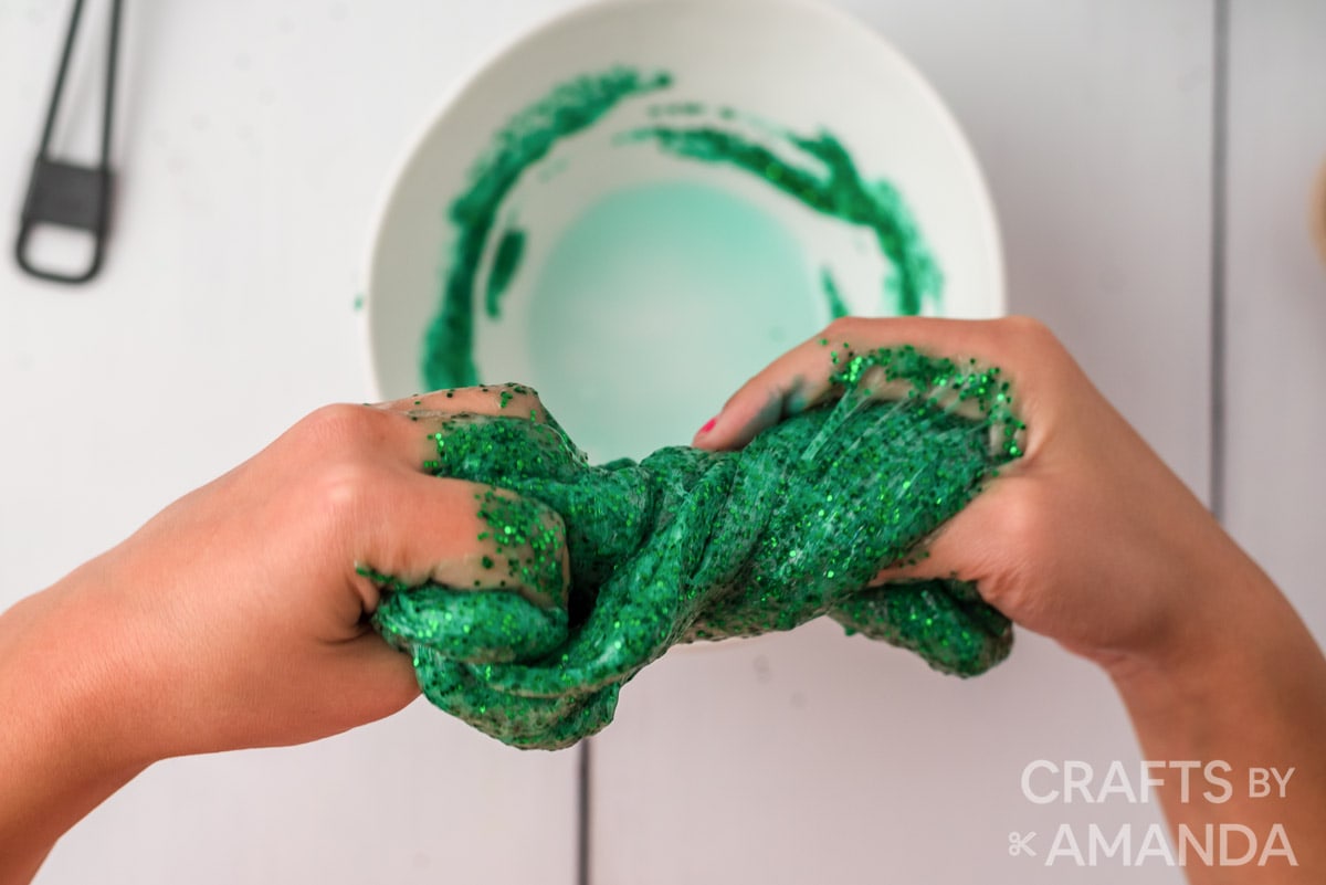 kneading green glitter slime