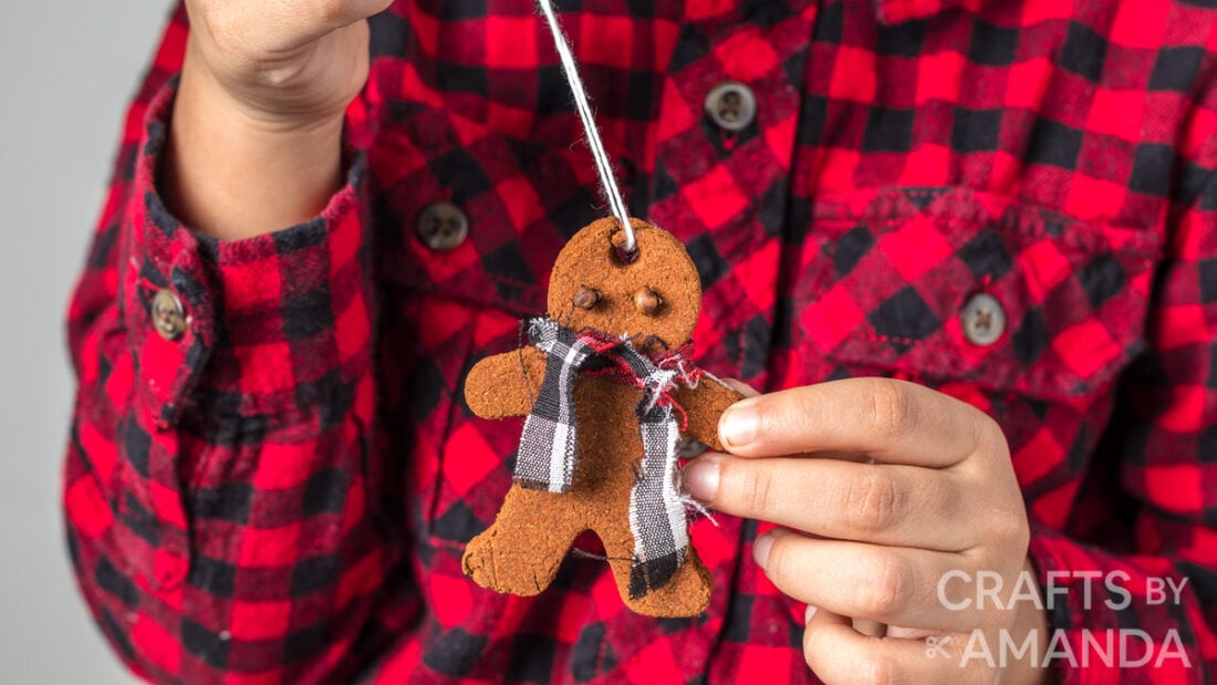 boy holding cinnamon ornament