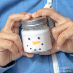 boy holding jar of snowman slime