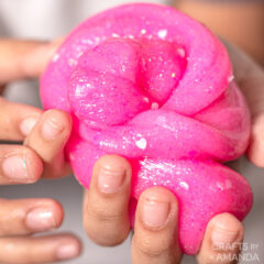 child holding pink valentine slime